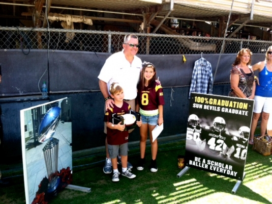 Head Coach Todd Graham takes some time to pose for pictures with fans.