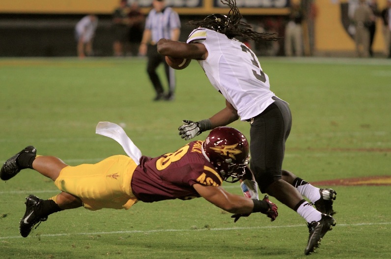 ASU Safety Viliami Moeakiola tackles in space